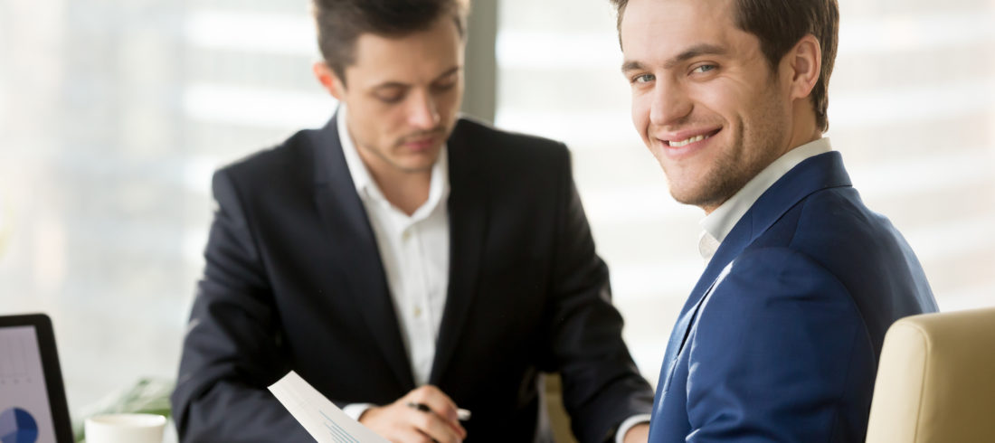 Smiling businessman, financial analyst or stock broker looking a