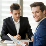 Smiling businessman, financial analyst or stock broker looking a